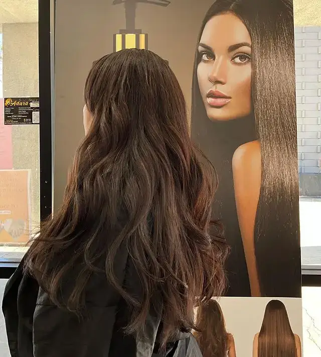 a person standing next to another person hair color desig