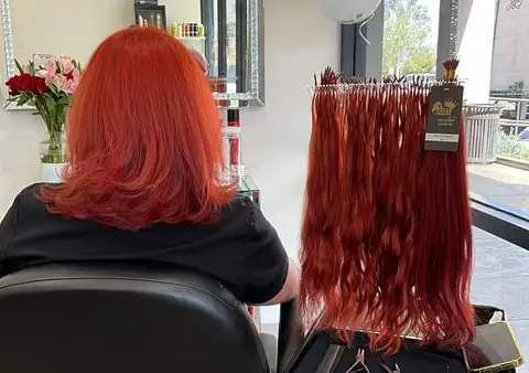 a person sitting in a chair showing color design hair color