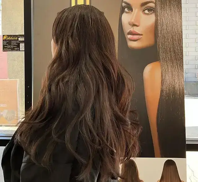 a person standing next to another person hair color desig
