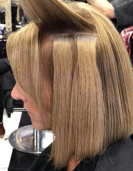 a person standing next to another person hair color desig