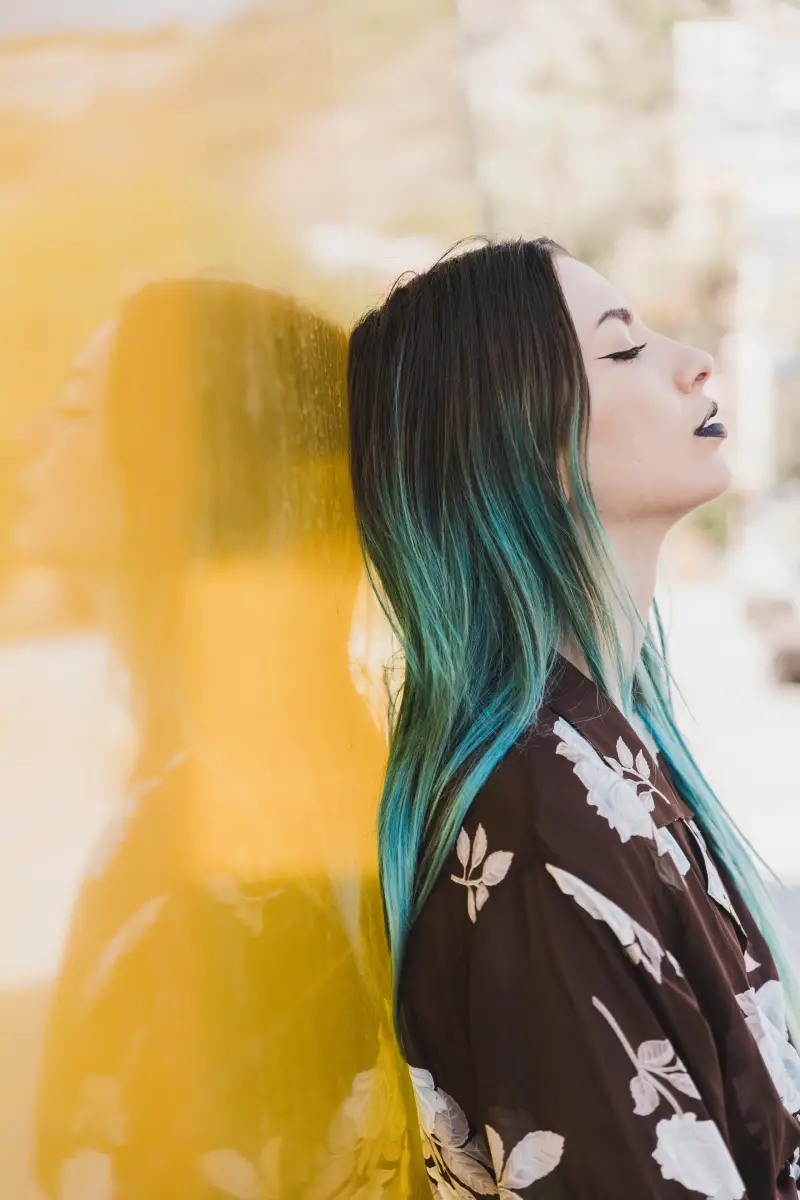 a person standing next to another person hair color desig